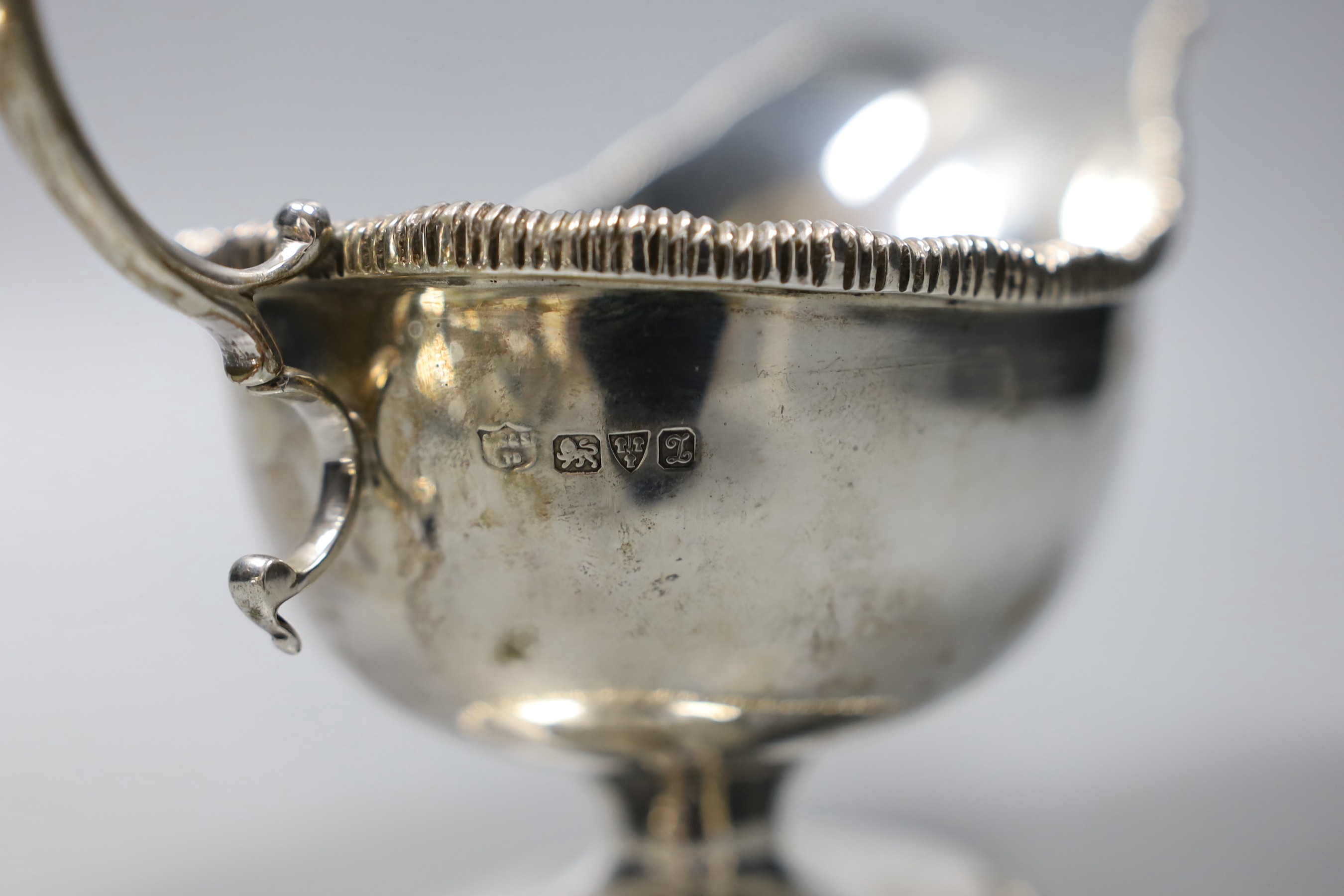 A pair of George V silver pedestal sauceboats with flying scroll handlse, Parker Brothers, Chester 1911, 14oz.